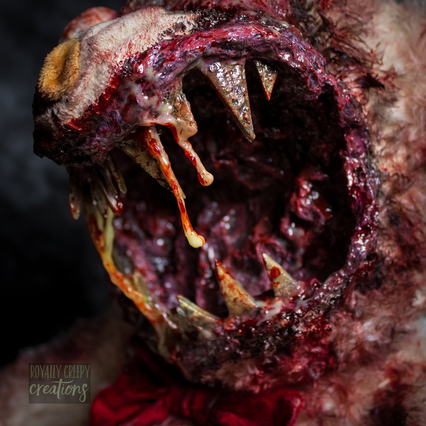Close-up of creepy teddy bear with sharp teeth and gore details.