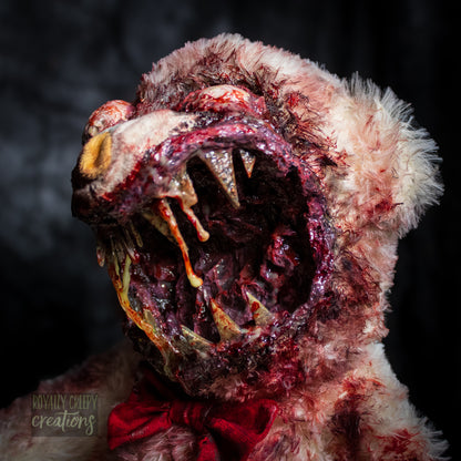 Close-up of creepy teddy bear with sharp teeth and gore details.