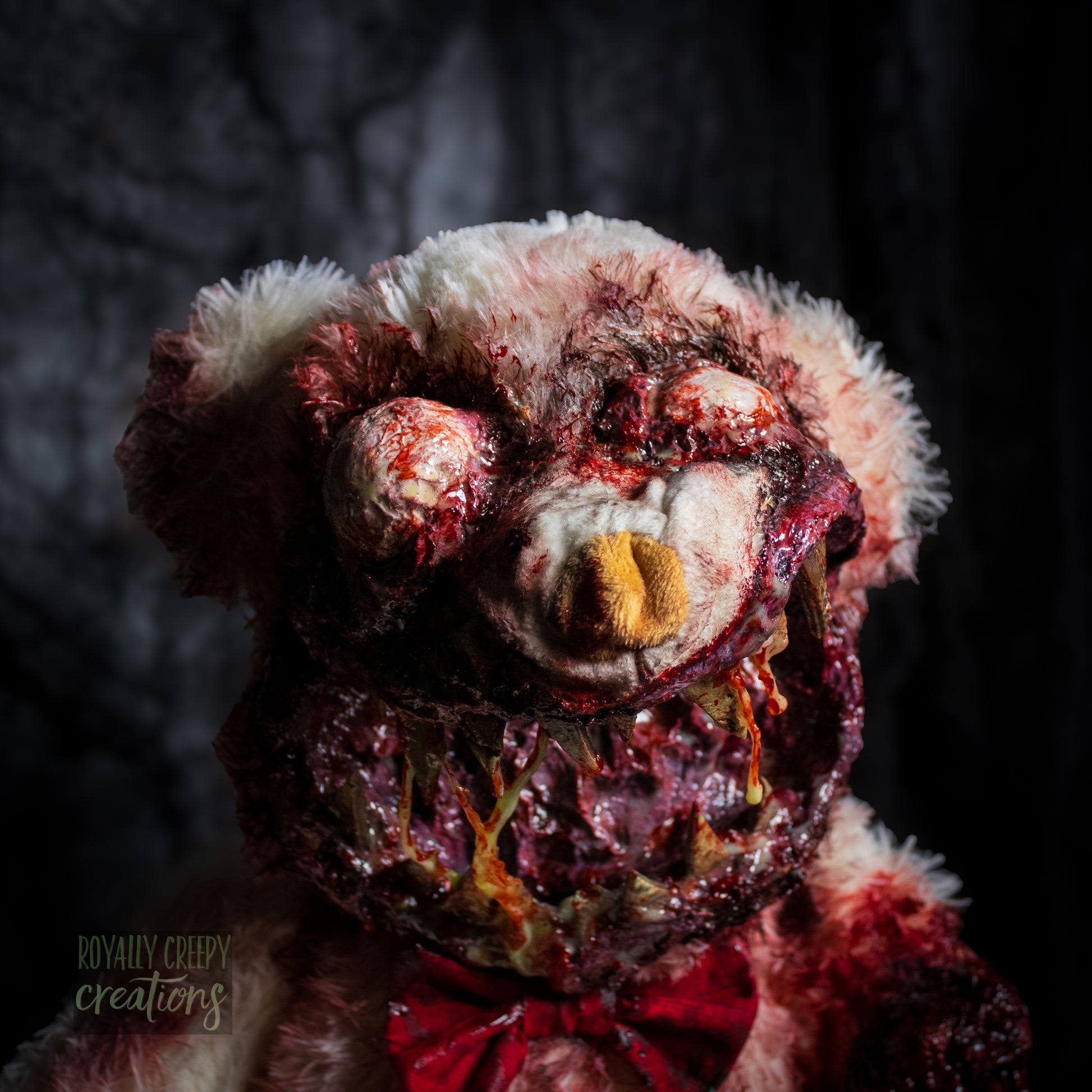 Close-up of creepy teddy bear with sharp teeth and gore details.