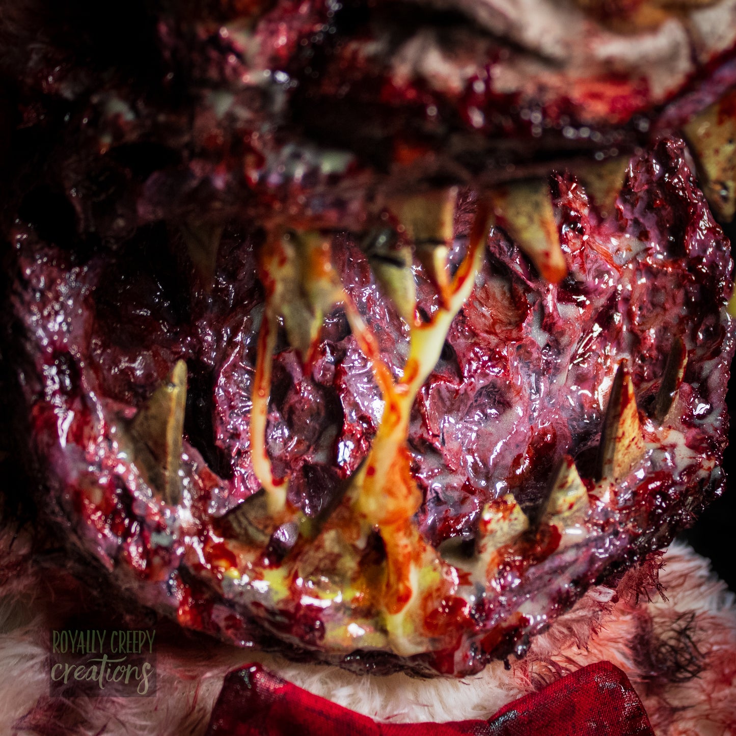 Close-up of creepy teddy bear with sharp teeth and gore details.