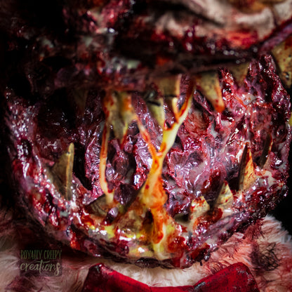 Close-up of creepy teddy bear with sharp teeth and gore details.
