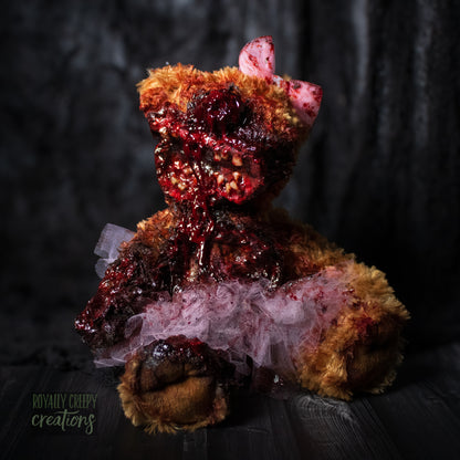 Horror teddy bear with exposed teeth, wearing a tutu & bow.