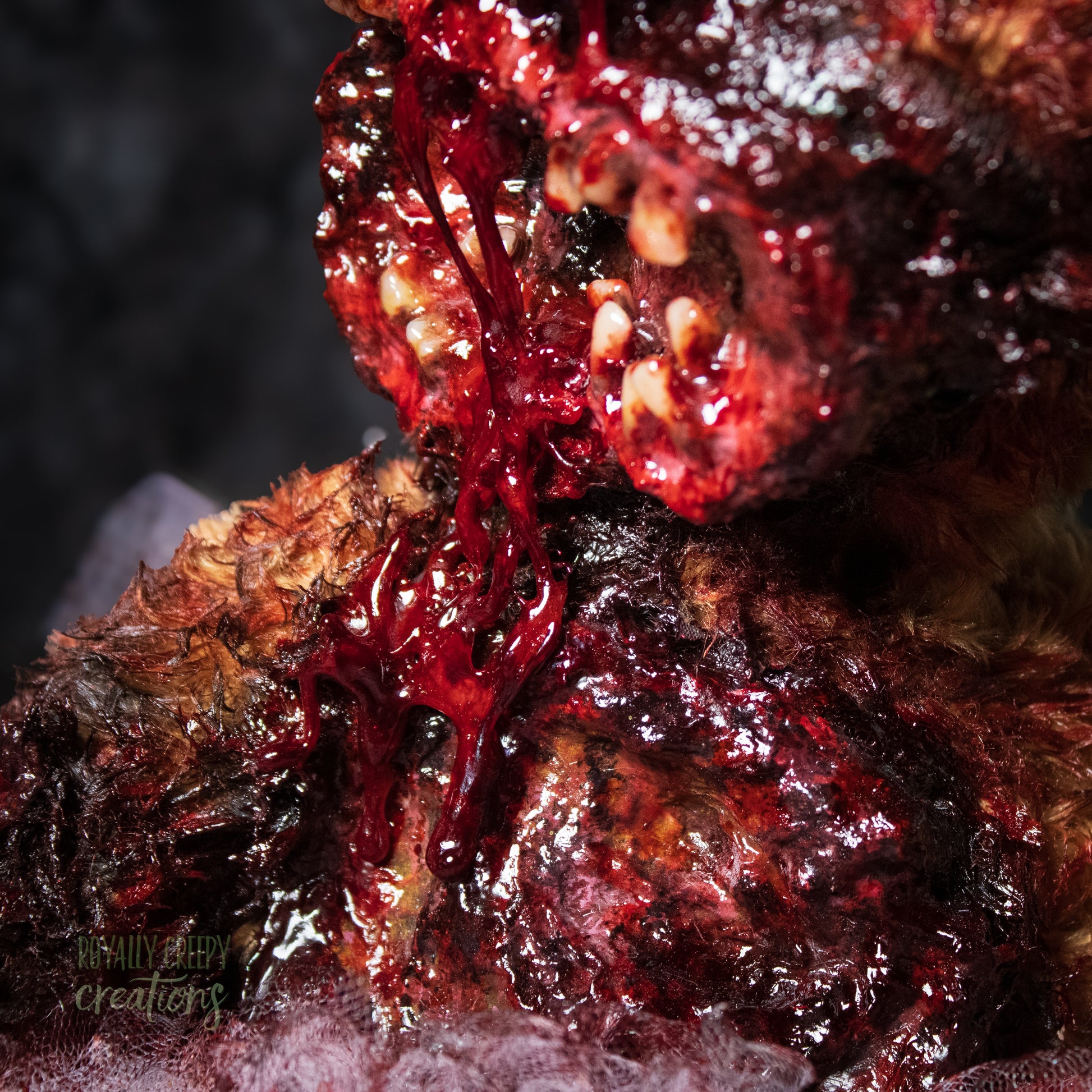 Close-up view of top to middle of horror teddy bear with exposed teeth.