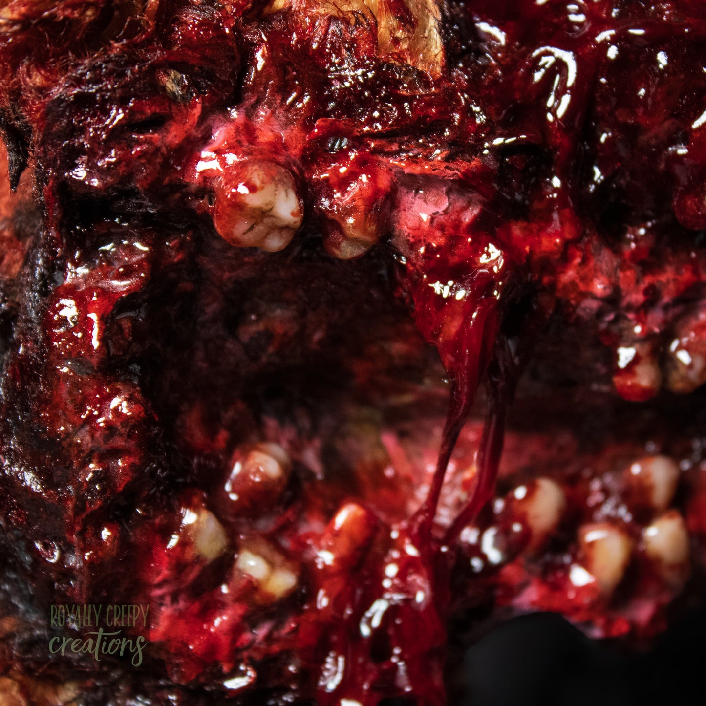 Extreme close-up of horror teddy bear's exposed teeth.