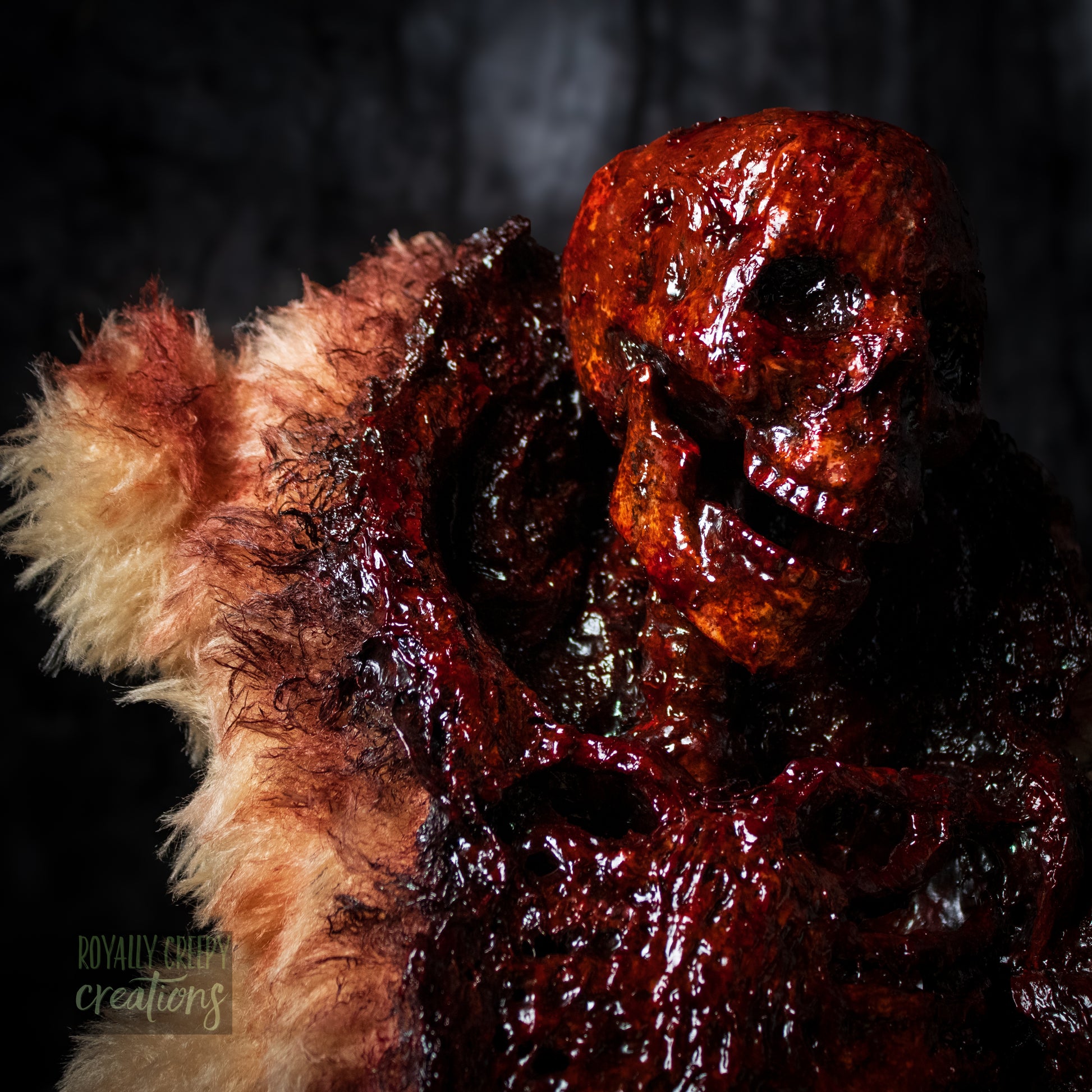 Close-up of top half of horror themed teddy bear torn open in the front with a gory skeleton emerging from it's body.