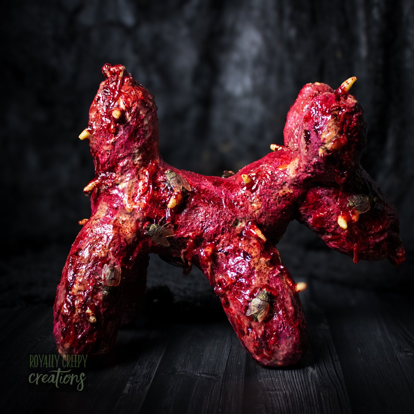 Side view of creepy plush balloon dog with insects and gore details.