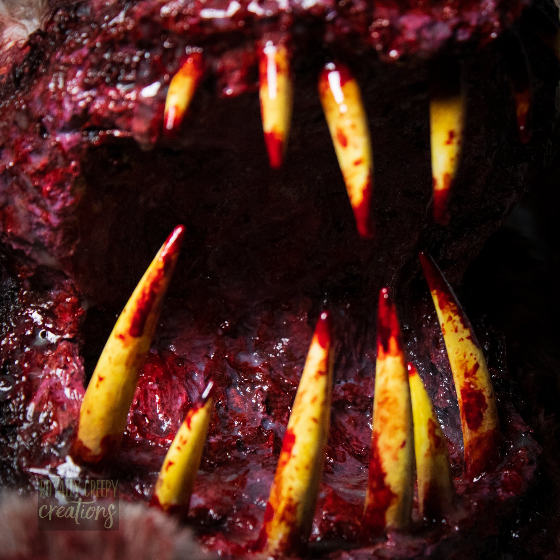 Extreme close-up of horror-themed bunny plushie's grotesque mouth with big sharp teeth.