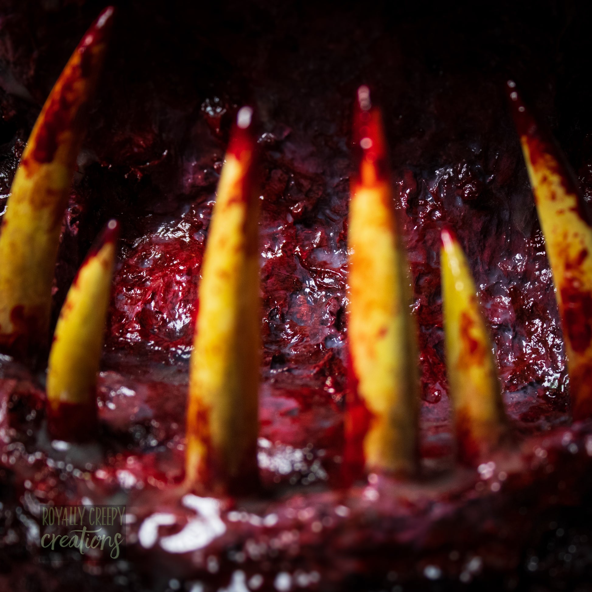 Extreme close-up of horror-themed bunny plushie's grotesque mouth with big sharp teeth.