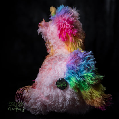 Back side of horror unicorn plush with logo on dark background.