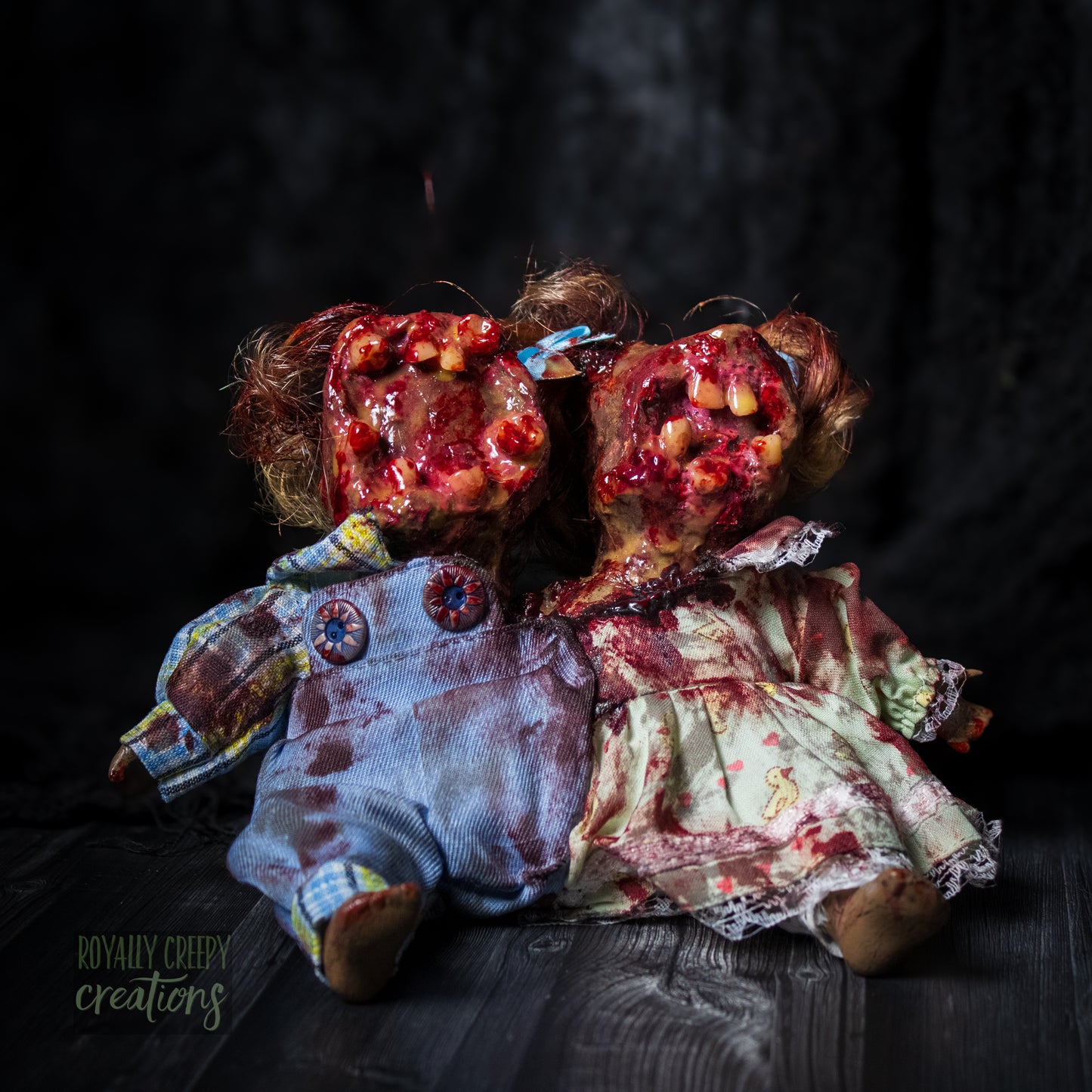 Artistic conjoined horror doll with a gaping mouth filled with teeth covering both faces.