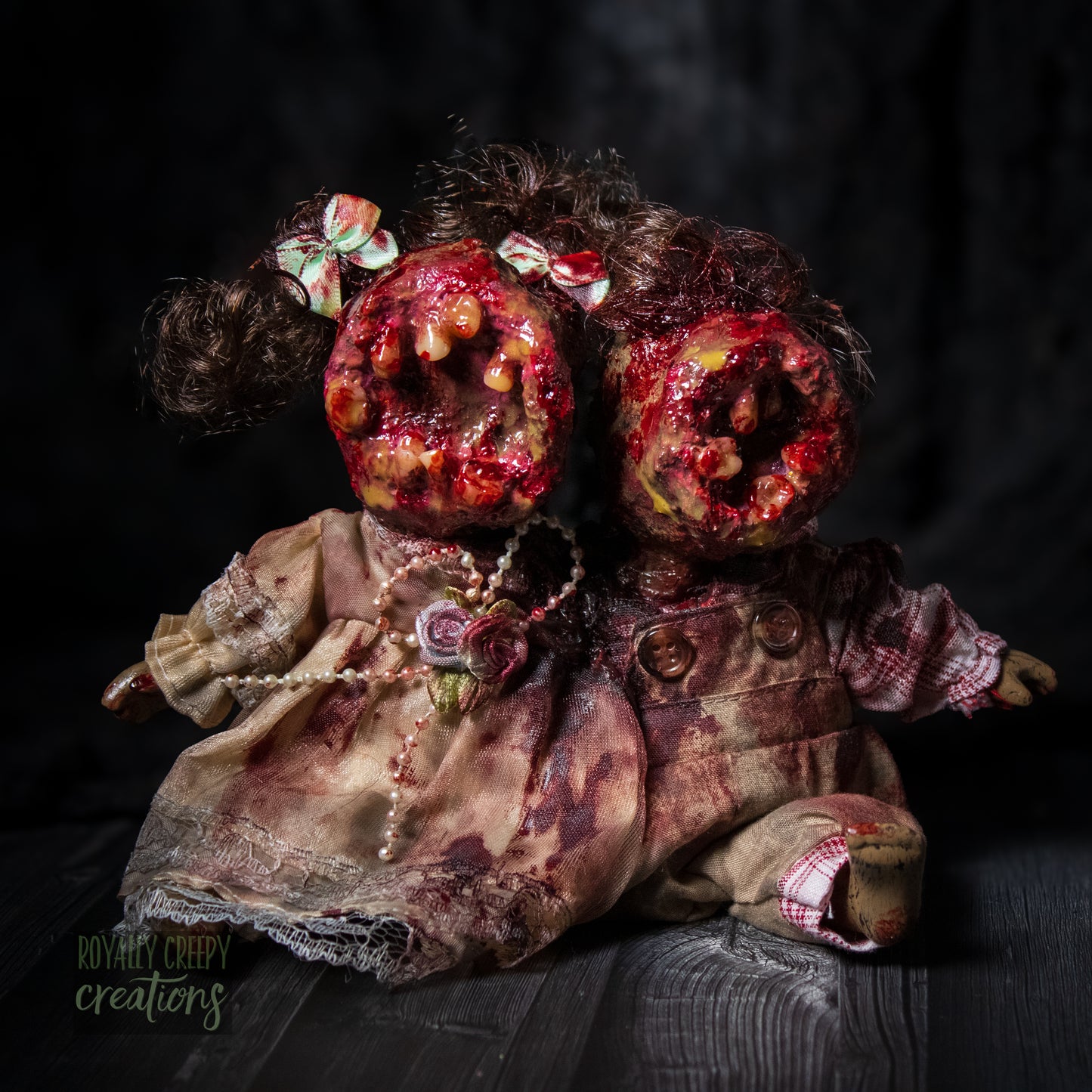 Artistic conjoined horror doll with a gaping mouth filled with teeth covering both faces.