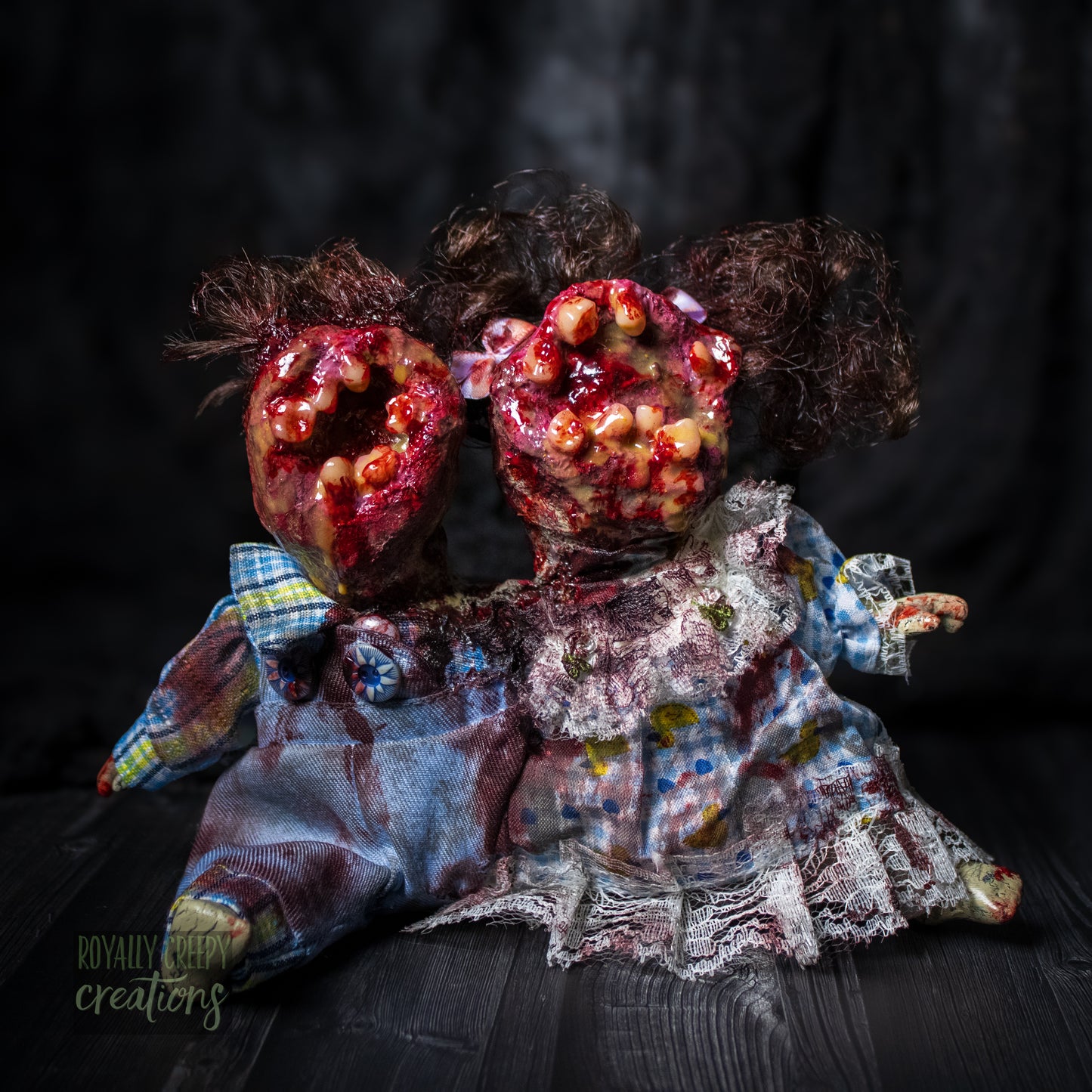 Artistic conjoined horror doll with a gaping mouth filled with teeth covering both faces.