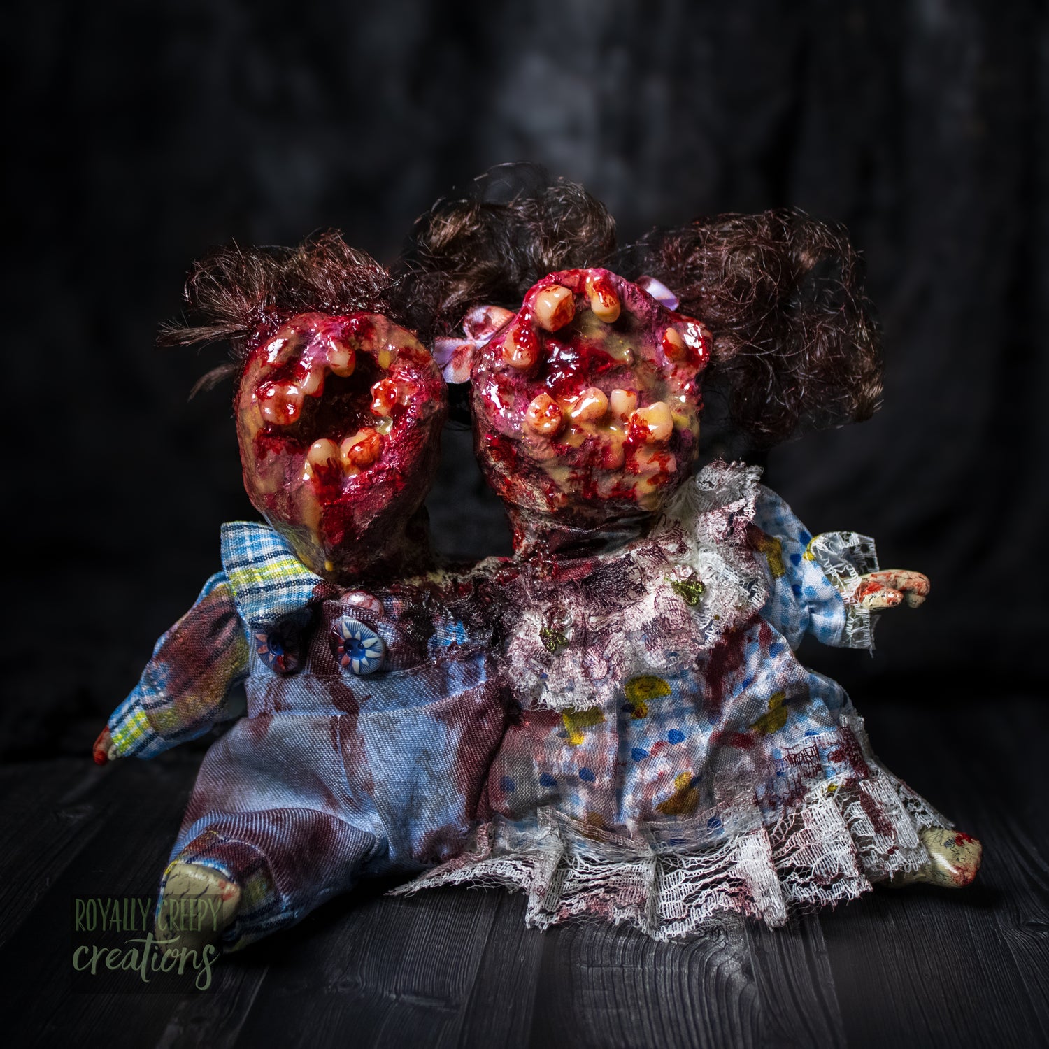 Artistic conjoined horror doll with a gaping mouth filled with teeth covering both faces.