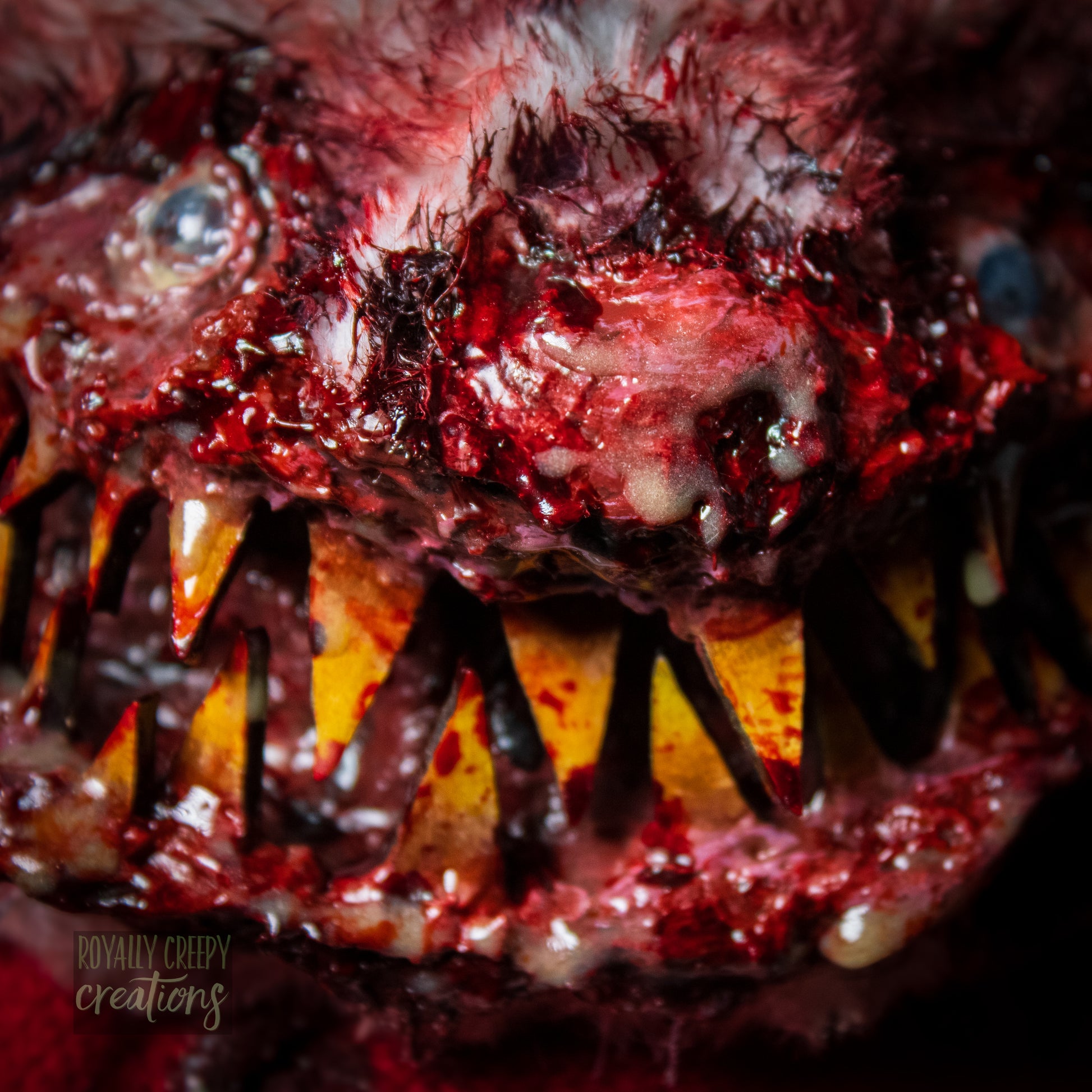 Close up of horror bird creature's face showing it's sharp teeth and ooze.
