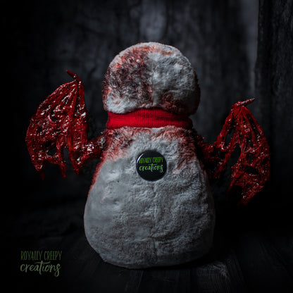 back of penguin with red wings and a red scarf on a dark background, featuring 'Royally Creepy Creations' logo.