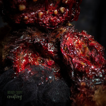 A close-up of a highly textured, gory Halloween prop resembling decaying flesh.