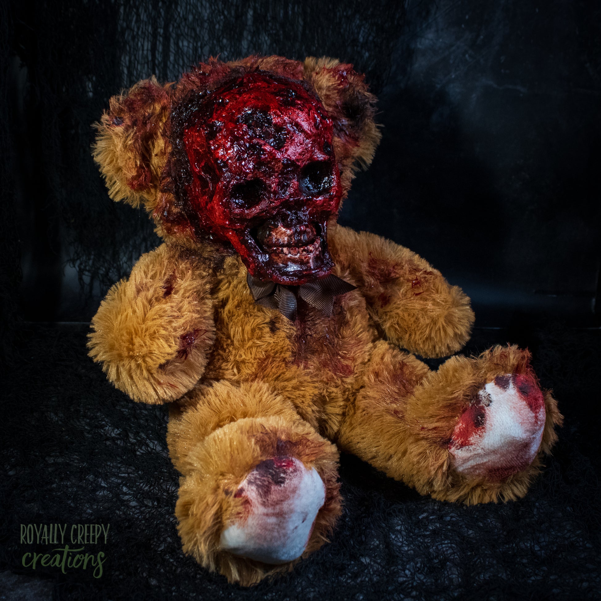 Gory horror teddy bear with an exposed bloody skull for a face
