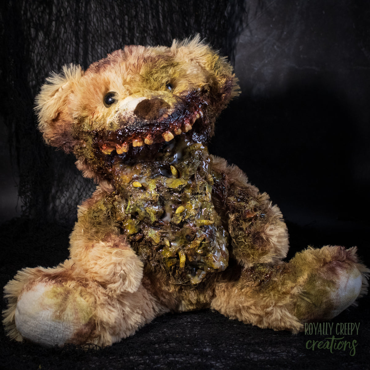 A horror-themed plush teddy bear with a grotesque, decayed mouth and exposed vomit set against a dark textured background. A 'Royally Creepy Creations' watermark is visible in the bottom corner.