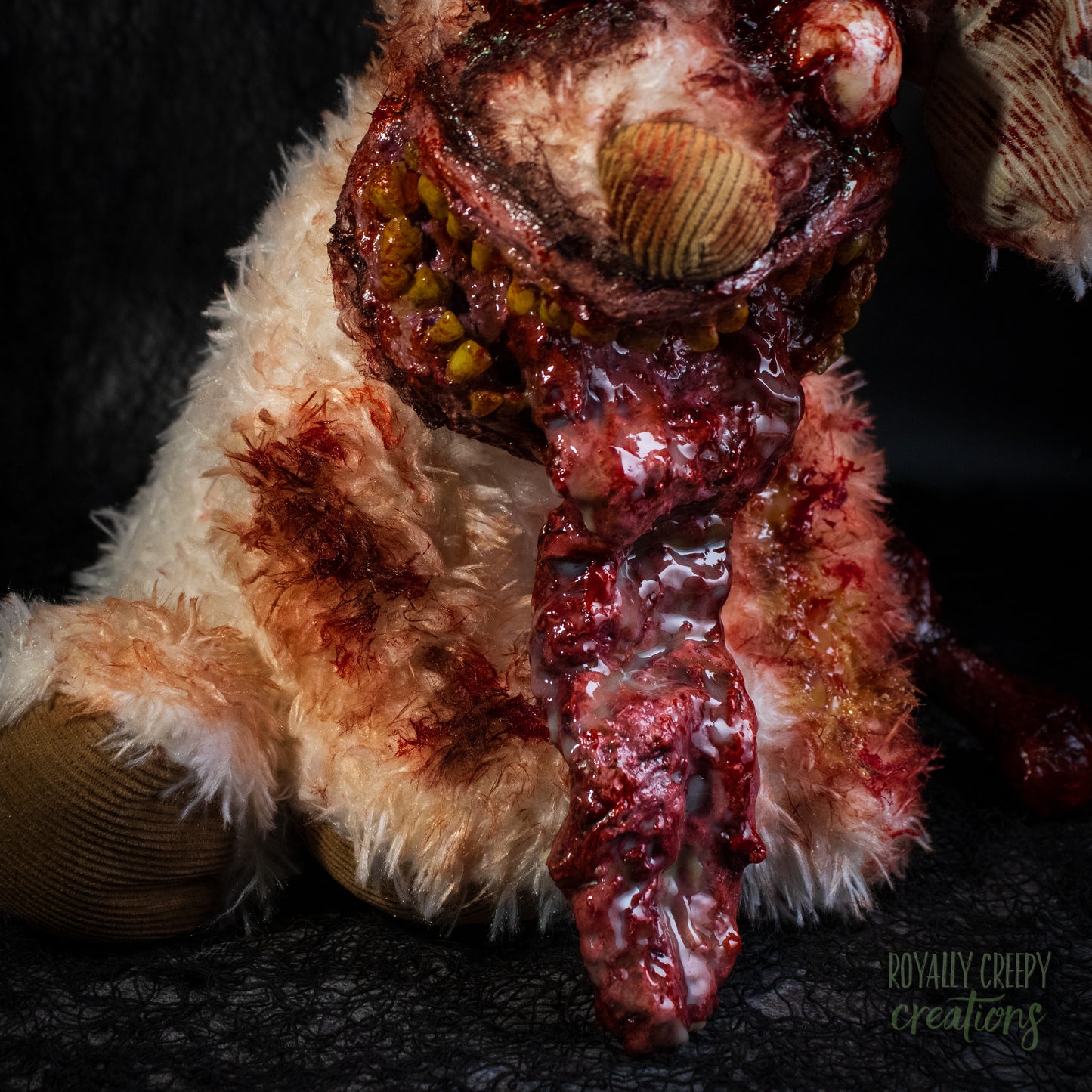 A close-up of horror-themed zombie dog's protruding tongue, posed against a dark textured background