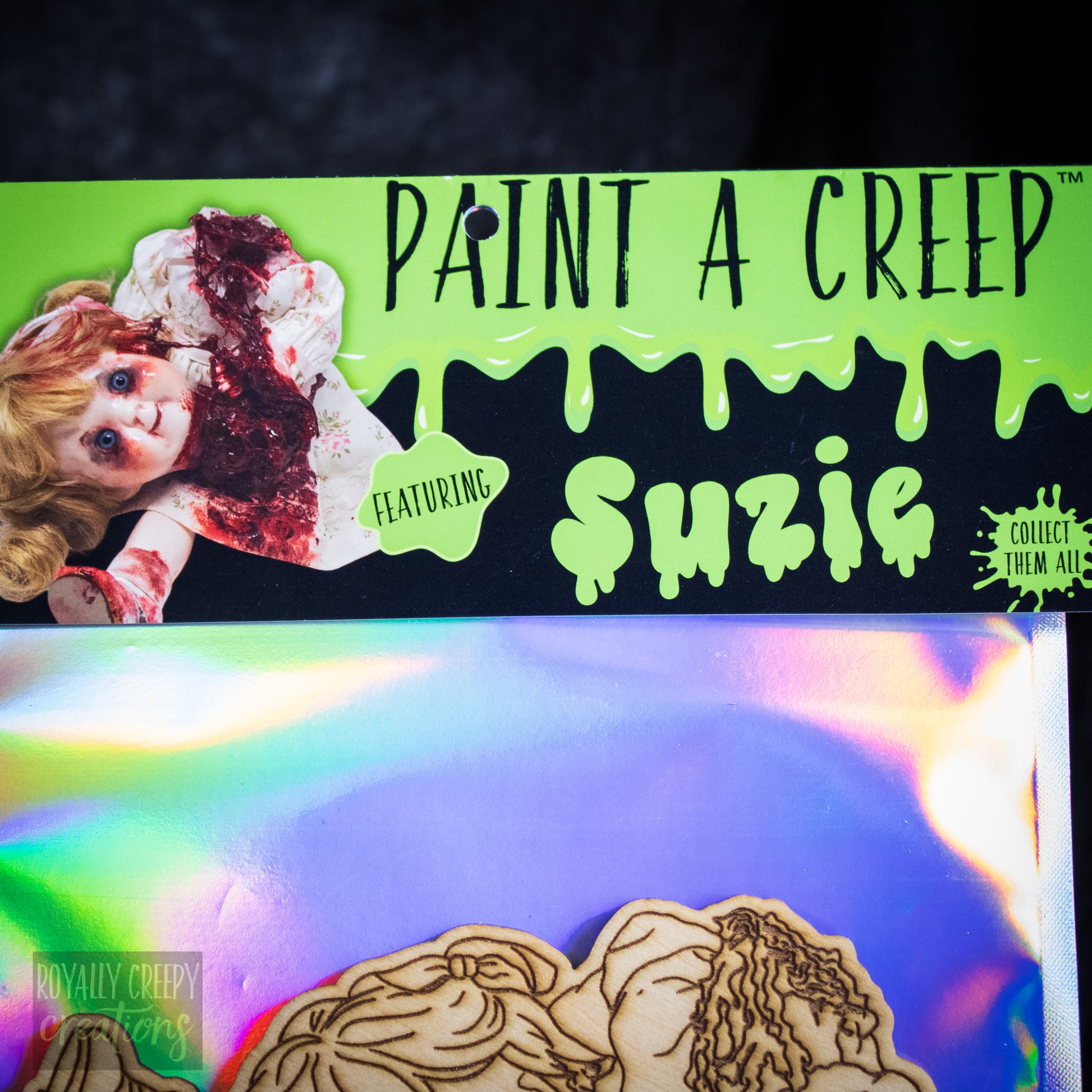 A craft kit label featuring 'PAINT A CREEP' and 'FEATURING Suzie'.