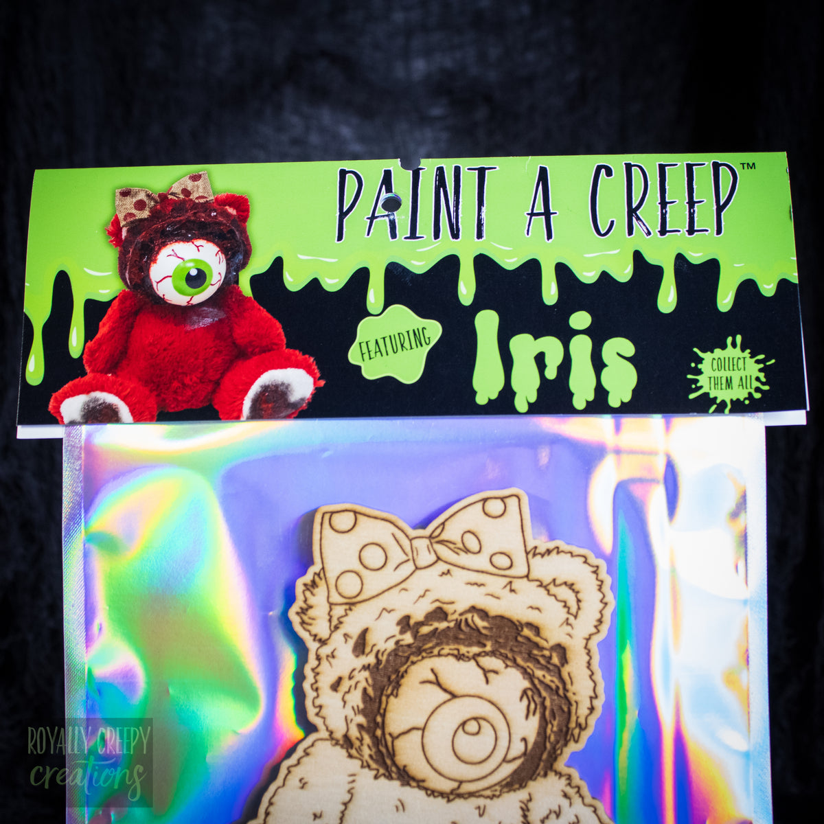 Paint a Ceep 'Featuring Iris' paintable wood kit in an iridescent holographic packaging.