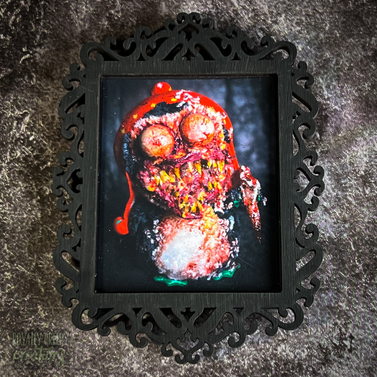 A gothic-style framed art print featuring a dark, eerie photograph of a grotesque penguin plushie.