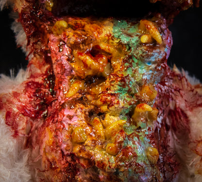 a close up of a pastel colored vomit & maggots.