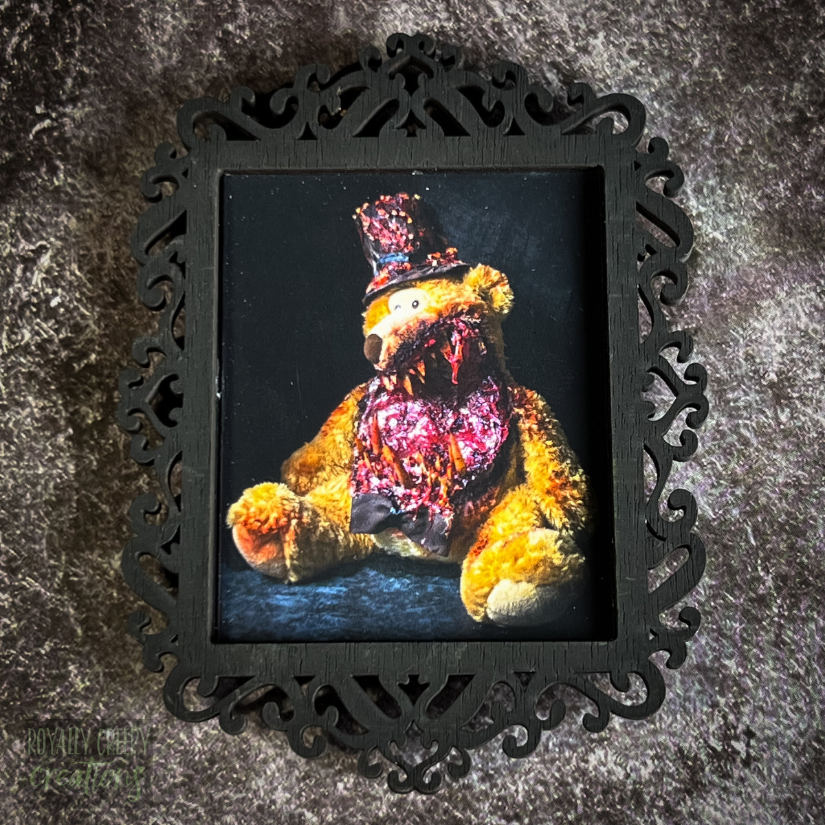 A gothic-style framed art print featuring a dark, eerie photograph of a grotesque teddy bear plushie.